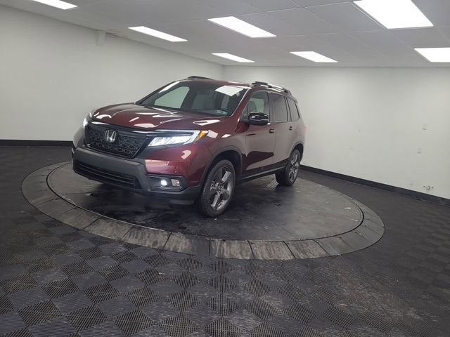2021 Honda Passport Touring in Burgundy — front three-quarter view